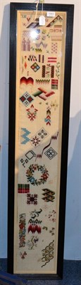 Lot 1063 - Late 19th century wool work long sampler, the geometric shapes and patterns, a floral wreath...