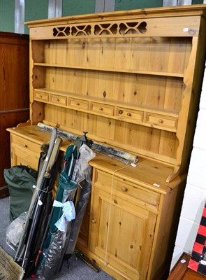 Lot 1100 - A pine dresser, 20th century, the rack with six drawers above inverted base, with three drawers and