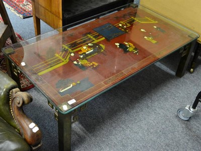 Lot 1106 - A Chinese lacquered coffee table with brass legs and a glass top