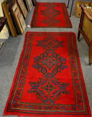 Lot 1116 - Two Ushak rugs, two watercolours depicting a mountainous landscape scene and a town market place, a