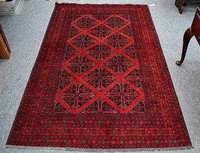 Lot 1117 - Afghan rug the indigo diamond lattice field enclosed by multiple borders, 194 by 126cm,...