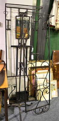 Lot 1126 - A group of wrought iron furniture comprising two hall stands, two up stands, two stick stands,...