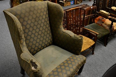 Lot 1130 - A George III wing chair, an Arts and Crafts rush seated chair in the manner of Liberty and a...