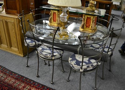 Lot 1145 - A contemporary nine piece wrought metal dining suite, comprising 5ft diameter circular glass...