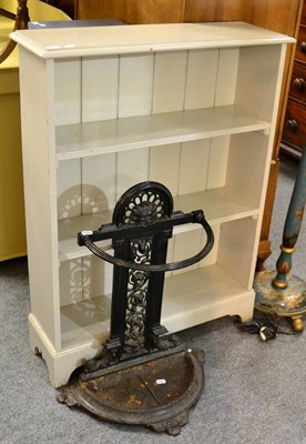 Lot 1161 - A cast iron stick stand, together with a painted pine three tier open bookcase