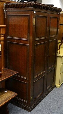 Lot 1165 - A panelled oak cupboard