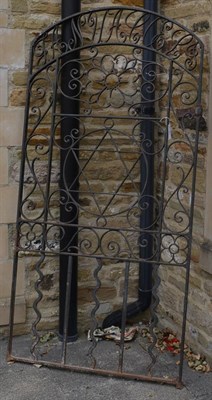 Lot 1181 - A wrought iron gate decorated with flowers, scrolls, script ant the star of David