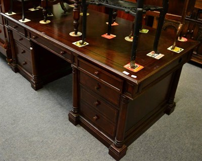 Lot 1310 - A mahogany twin pedestal desk, six short over one long drawer