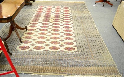 Lot 1330 - Lahore Bukhara carpet, Punjab, the pale camel field with columns of Turkmen guls enclosed by...