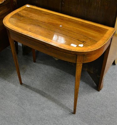 Lot 1331 - An early 19th century rosewood and satinwood banded fold over card table