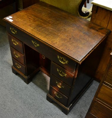 Lot 1334 - An 18th century oak kneehole desk with sliding mechanism