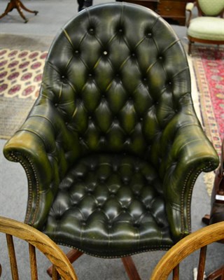 Lot 1345 - A green leather button backed desk chair