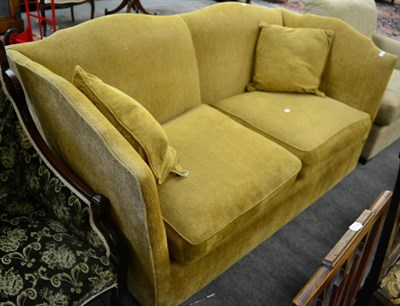 Lot 1364 - A feather filled two-seater knoll sofa, modern, upholstered in yellow fabric, with serpentine...