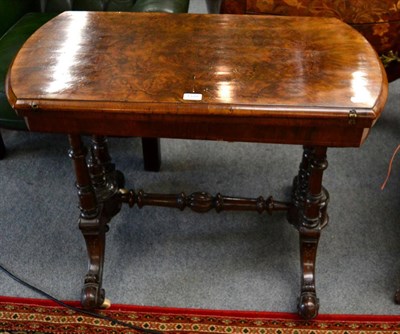 Lot 1370 - A Victorian walnut fold-over games table