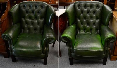 Lot 1372 - A pair of green leather button back wing chairs