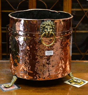 Lot 1376 - A copper coal bucket on three feet and with lion mask and ring handles