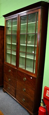 Lot 1404 - A 19th century mahogany glazed bookcase with six drawers base