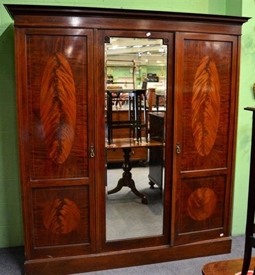 Lot 1407 - Mahogany veneered inlaid triple wardrobe, one door with mirrored panel