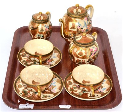 Lot 1 - A Japanese Satsuma pottery part tea service, decorated with seated women and monks in an...
