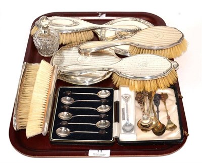 Lot 11 - A five piece silver dressing table set, a silver backed dressing table mirror and matching...