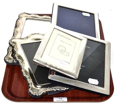 Lot 12 - A silver framed mirror and four various silver frames