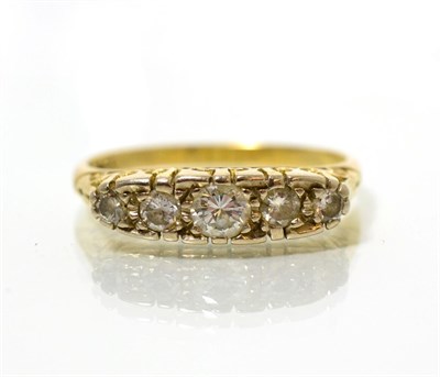 Lot 55 - A diamond five stone ring, graduated round brilliant cut diamonds in a carved scroll setting, total