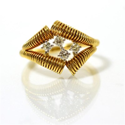 Lot 76 - An 18 carat gold diamond ring, four round brilliant cut diamonds in claw settings, to an asymmetric