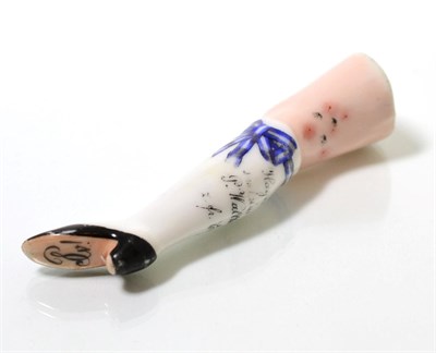 Lot 86 - A 19th century Continental china pipe tamper in the form of a lady's leg