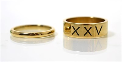 Lot 95 - A 9 carat gold band ring, engraved with Roman numerals 25/12/2006, finger size W and a 9 carat gold