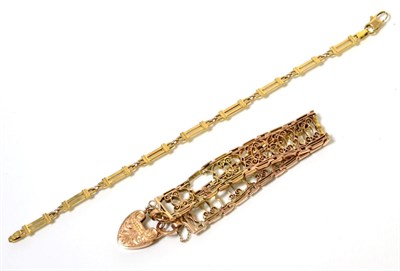 Lot 99 - A fancy link bracelet, of knife edge scroll design, with a chased padlock clasp (af), length...