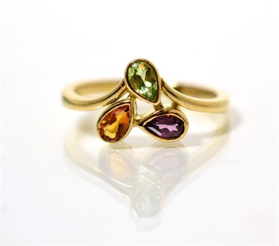 Lot 108 - An 18 carat gold peridot, citrine and garnet ring, oval cut stones in rubbed over settings, to...