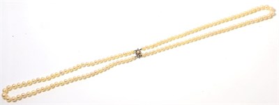 Lot 113 - A cultured pearl necklace, with a diamond and pearl set clasp, two strands of graduated...