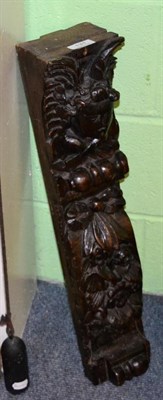 Lot 131 - A 17th century carved oak term figure, as the head and wings of an angel over a ribbon tied...