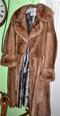 Lot 142 - Dysons Furriers light mink coat, with attached matching belt and decorative faux agate buttons...