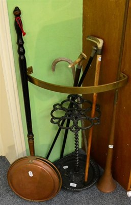 Lot 146 - A Victorian cast iron stick stand, a quantity of sticks including one silver mounted example