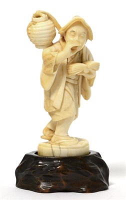 Lot 168 - A Meiji period ivory okimono of a traveller figure