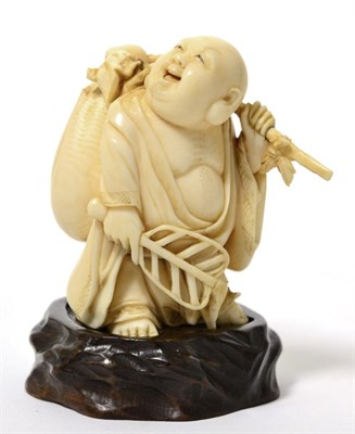 Lot 169 - A Meiji period ivory okimono of a travelling Buddha signed Zhong Shou