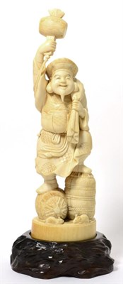 Lot 172 - A Meiji period ivory okimono of a laughing Buddha with hammer signed Xue Ming