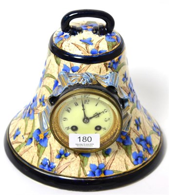 Lot 180 - A pottery bell shaped striking mantel clock