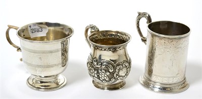 Lot 182 - Three various small silver Christening mugs, a repousse decorated baluster example, London...