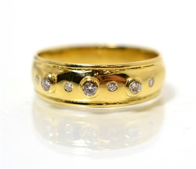 Lot 213 - An 18 carat gold diamond band ring, with round brilliant cut diamonds in alternating rubbed...