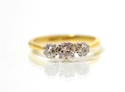 Lot 214 - A diamond three stone ring, graduated old cut diamonds in claw settings, to knife edge...