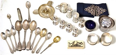 Lot 224 - A selection of silver items consisting of peppers, Garrard & Co table lighter, ashtray, nurses belt