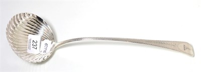 Lot 237 - A George III silver ladle with shell form bowl and bright cut decoration, London 1790
