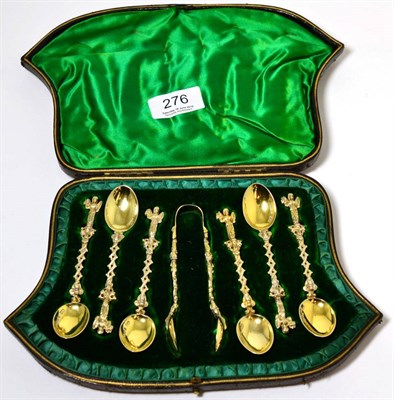 Lot 276 - A cased set of six cast silver gilt apostle spoons, together with matching tongs by Lee &...