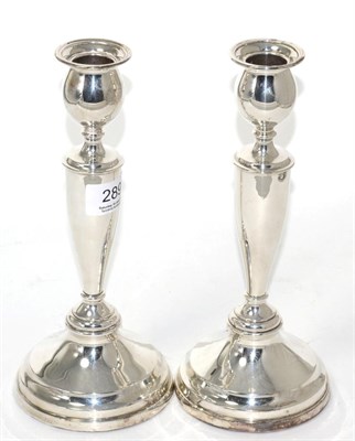 Lot 289 - A pair of Georgian style silver candlesticks, London, 1918, weighted boxes 23.5cm high (2)
