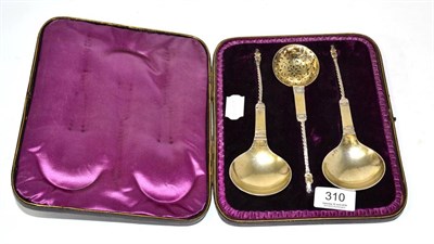 Lot 310 - A Victorian silver set of two spoons and matching strainer each with lion and shield terminal...