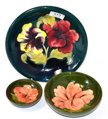 Lot 313 - Three Moorcroft pottery Hibiscus pattern bowls, 22cm, 14.5cm and 9.5cm diameters, all with...