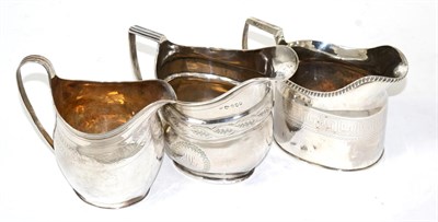 Lot 314 - A George III Newcastle silver cream jug; another similar London example; and a Sheffield...