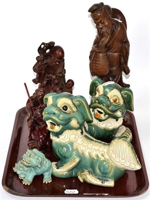 Lot 328 - Four Chinese rootwood figures and three modern pottery models of dogs of fo
